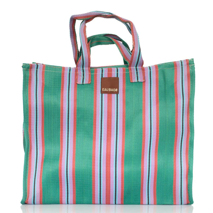 Eau Bags Vacay travel bag in green, pink and lilac stripe with a brown leather logo tag.