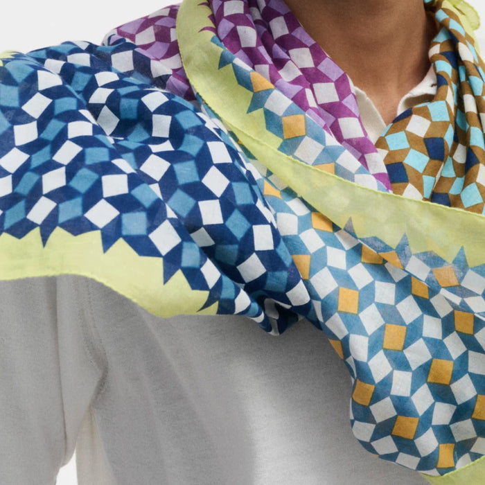 Epice cotton square bandana with a blue, navy, mustard and purple geometric print and lime border, knotted at the neck
