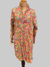 Colorful floral dress on a mannequin against a gray background