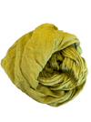 Rolled-up green towel on a metallic surface