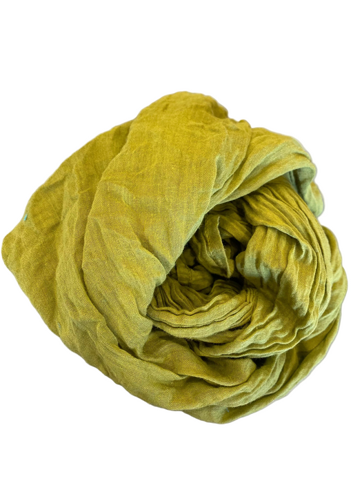 Rolled-up green towel on a metallic surface