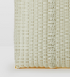 detail of woven material of bag, on a white background