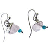 Pair of earrings with white stone and turquoise bead on a white background