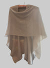 Beige sweater draped over a chair with a blurred indoor background