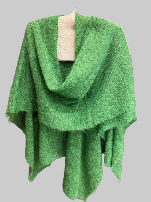 Green textured blanket on a gray surface