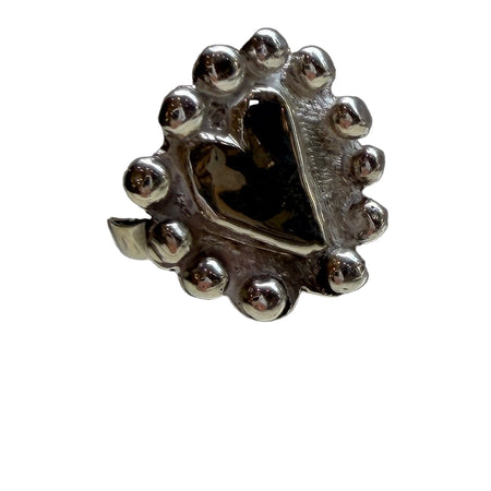 Silver ring with a unique design on a reflective surface