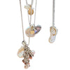 Necklace with seashell and starfish charms on a wooden surface