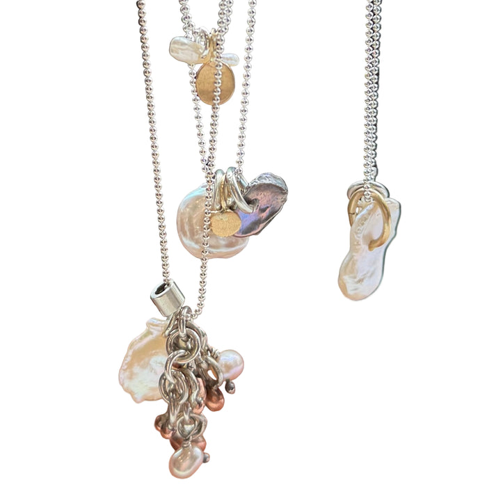 Necklace with seashell and starfish charms on a wooden surface