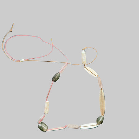 Necklace with various beads on a dark surface