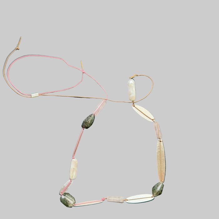 Necklace with various beads on a dark surface