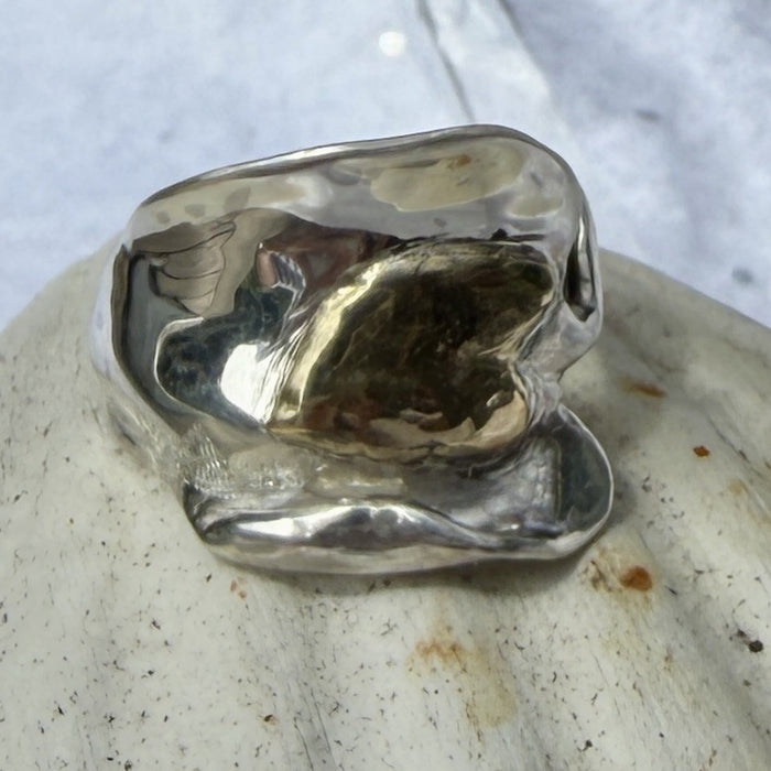 10 ct gold heart ring on broad wave of silver