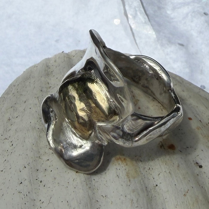 10 ct gold heart ring on broad wave of silver