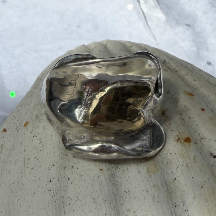 10 ct gold heart ring on broad wave of silver