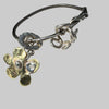 Silver bracelet with floral charms on a shell