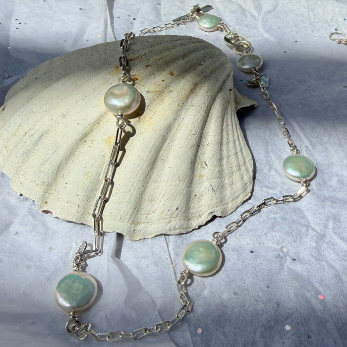 Pearl and silver charm necklace