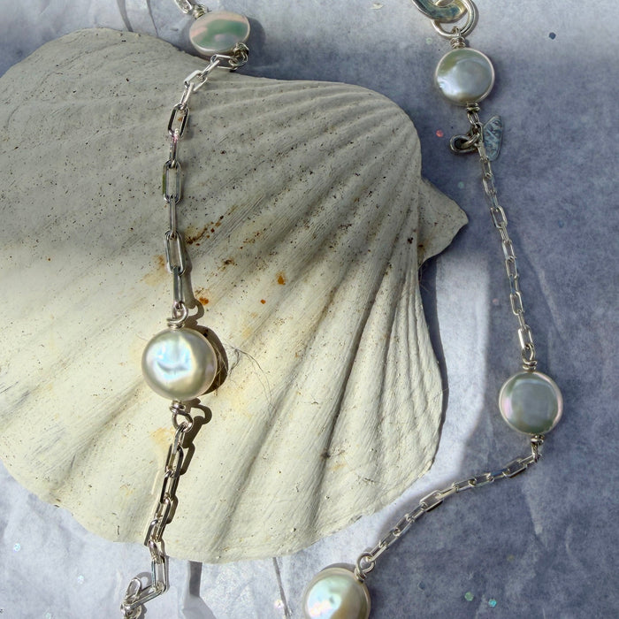 Pearl and silver charm necklace