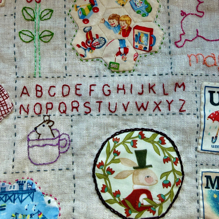 Hand stitched baby quilt in linen and cotton