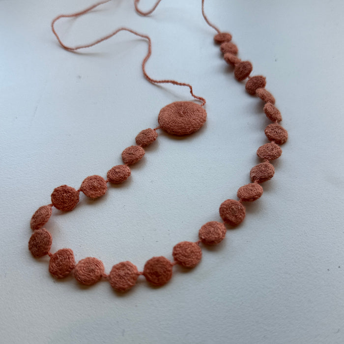 Flat disc hand crocheted necklace in apricot
