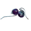 Silver earrings with purple gemstones on a light background