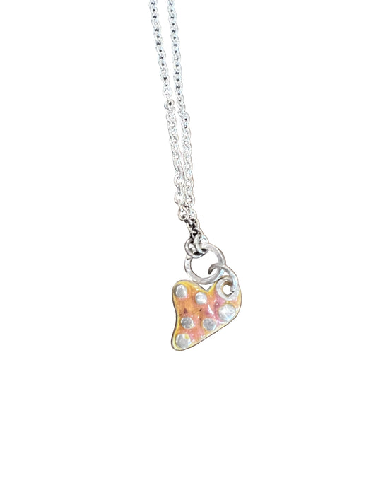 Necklace with a heart-shaped pendant on a wooden surface