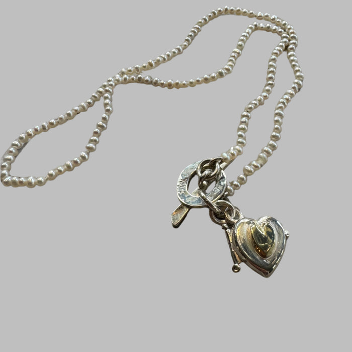 White seed pearl necklace with heart shaped locket