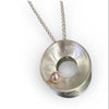 Silver necklace with a round pendant on a white background
