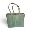 Woven basket with handles on a white background