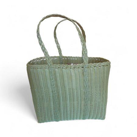 Woven basket with handles on a white background