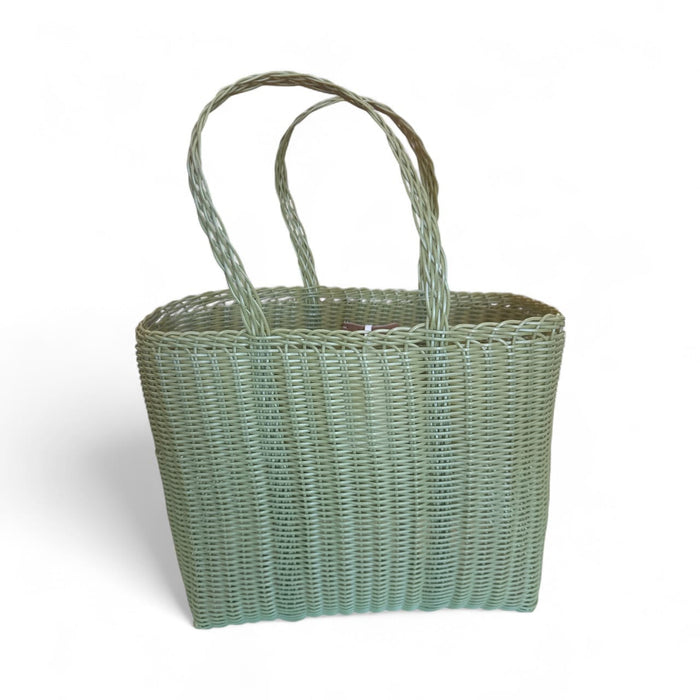 Woven basket with handles on a white background