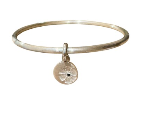 Petite flower stamp charm on silver bangle
