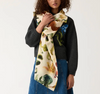 Woman wearing a floral scarf with a plain background