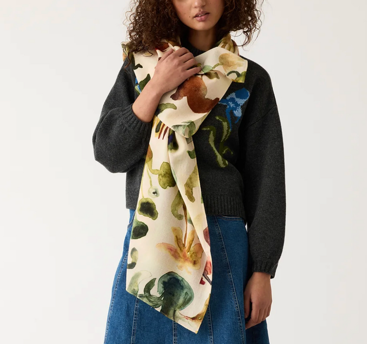 Woman wearing a floral scarf with a plain background