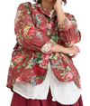 Person wearing a floral shirt over a white top with a red skirt on a white background