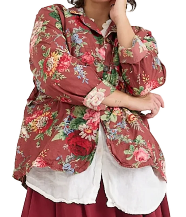 Person wearing a floral shirt over a white top with a red skirt on a white background
