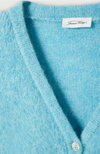 Close-up of the V neck and label on the American Vintage East cardigan in sky blue