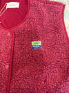 Close-up of the AMV patch on the American Vintage Hok boucle fleece vest in raspberry red