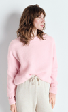 Model wearing the American Vintage Vitow alpaca crew knit in sugared almond pale pink