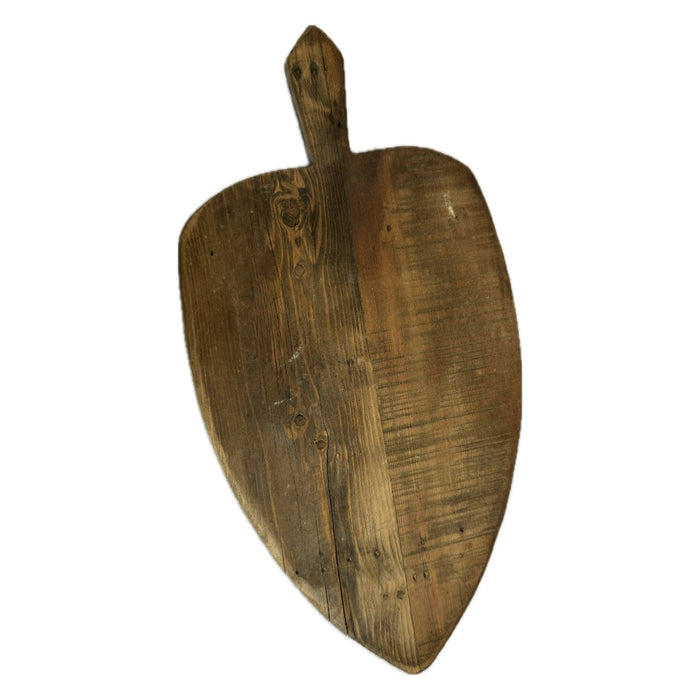 Shield-shaped vintage wooden bread board with a pointed handle and visible knots in the grain