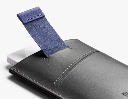 Bellroy Card Sleeve wallet in charcoal/cobalt, pulling cards out with the tab