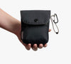 Bellroy Cinch Pocket pouch in black, held in hand to show its size