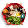Bellroy Market Tote in red, a large shopping tote bag packed with groceries and fresh produce, top view