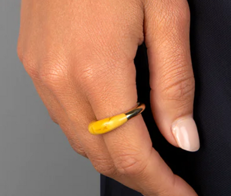 Dinosaur Designs Horn ring in honeycomb yellow resin worn on the hand
