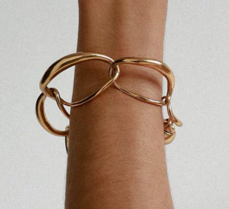 Dinosaur Designs Liquid chain bracelet in gold worn on the wrist