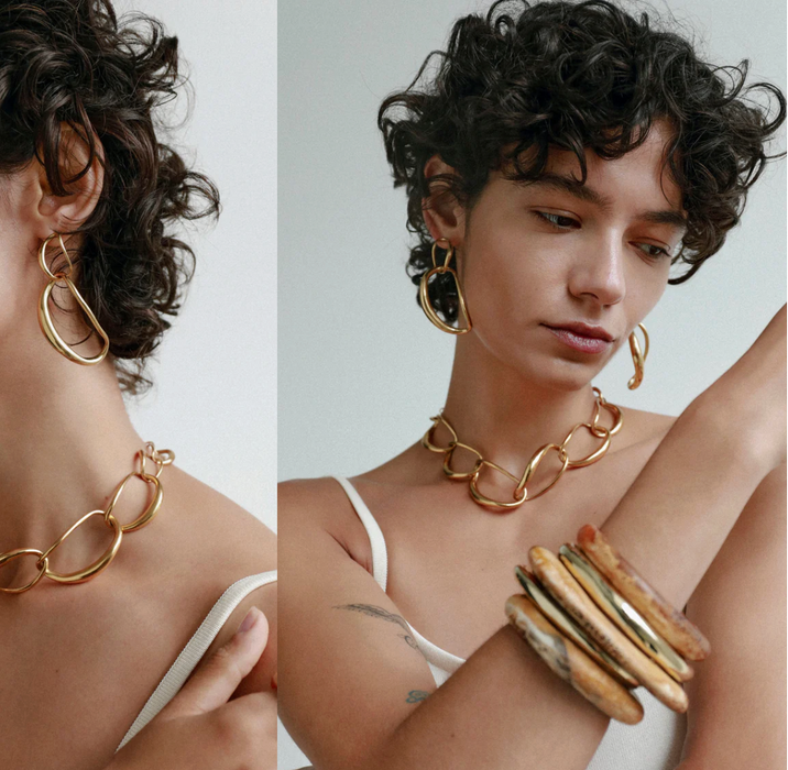 Dinosaur Designs Liquid chain choker worn with stacked gold bangles
