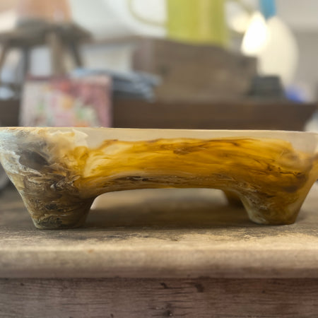 Dinosaur Designs Long offering bowl in light horn resin, side view on timber