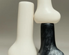 Dinosaur Designs medium Stem vase in slate, styled with white resin vases