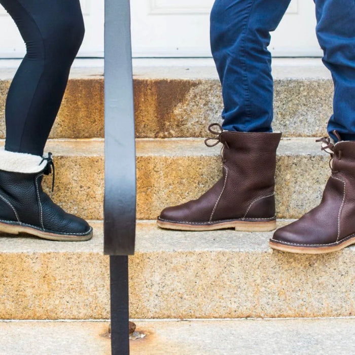 Duckfeet Arhus shearling lined leather boots in black and brown, worn on stone steps