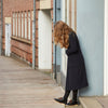 Duckfeet Sjaelland slate leather desert ankle boot worn with navy dress and black tights