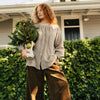 Etika brown gingham linen blouse styled with wide-leg brown trousers, full-length view
