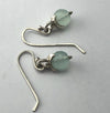 Flick Pope chalcedony and silver hook earrings, laid flat